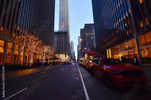  Night street view and city life on Sixth Avenue or Avenue of the Americas, Midtown Manhattan, New York.