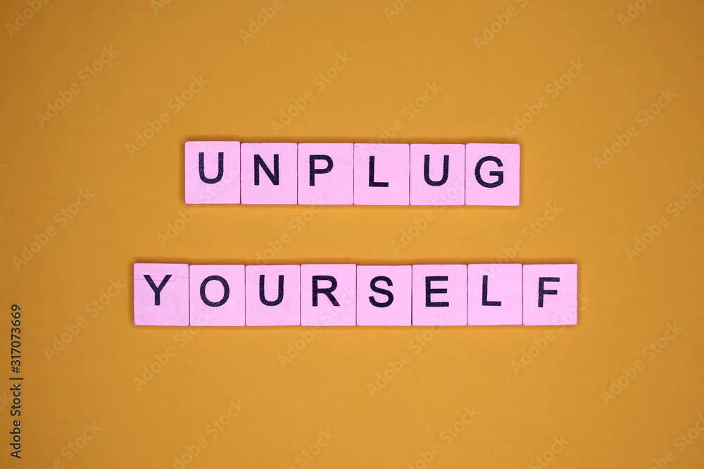 Unplug yourself, on a yellow background. Motivational poster Unplug yourself, on a yellow background. Motivational poster