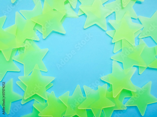 blue background with yellow-green stars laid out in the shape of a circle, free space for your text.
