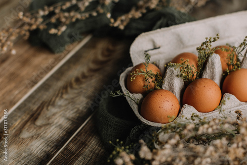 Eggs in a box on a wooden background decorated in a rustic style