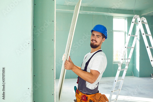 Photography Worker builder installs plasterboard drywall at a construction