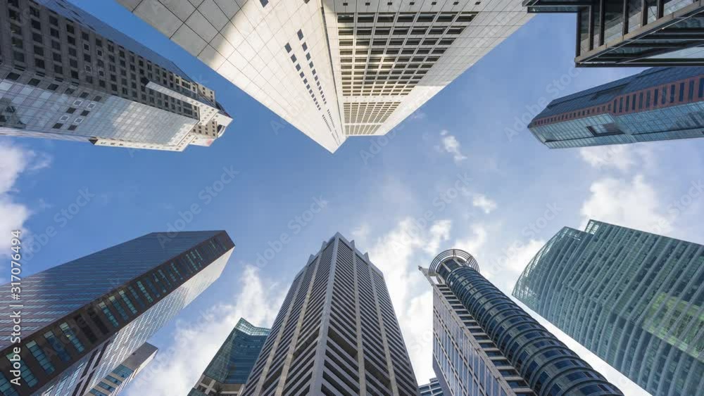 Downtown Singapore time lapse view, looking up at office buildings architecture in the financial district of Singapore Downtown Singapore time lapse view, looking up at office buildings architecture in the financial district of Singapore