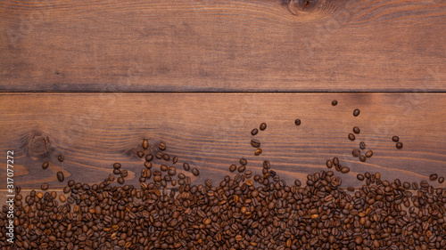 roasted coffee beans lie on a wooden background