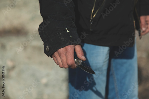 young man hand pocket knife