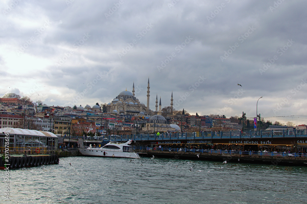 Istanbul, Turkey-January 03, 2020: Beautiful landscape photo of city. The Galata Bridge over the Golden Horn in Istanbul. Buildings and ancient the Nuruosmaniye Mosque on the top of the hill