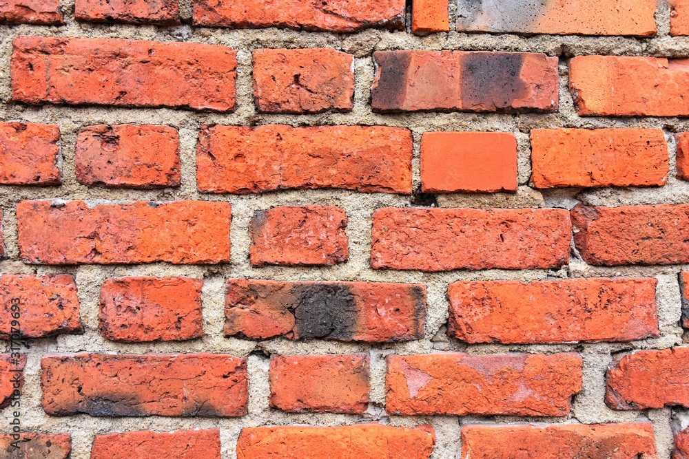 Grunge red brick wall with textured blocks, selective focus. Old stone wall. Red bricks background. Construction works. Brickwork. Grunge red brick wall with textured blocks, selective focus. Old stone wall. Red bricks background. Construction works. Brickwork.