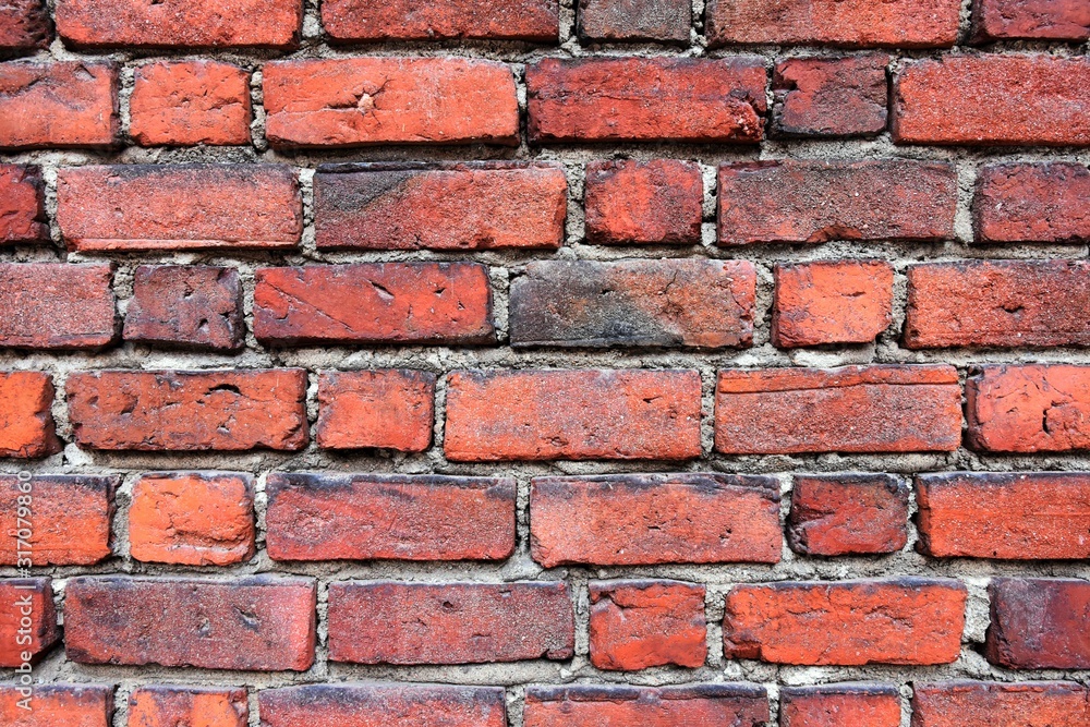 Grunge red brick wall with textured blocks, selective focus. Old stone wall. Red bricks background. Construction works. Brickwork. Grunge red brick wall with textured blocks, selective focus. Old stone wall. Red bricks background. Construction works. Brickwork.