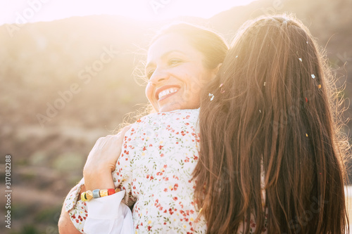 Quadro su tela Love and friendship diversity concept - couple of females hug with love and rela