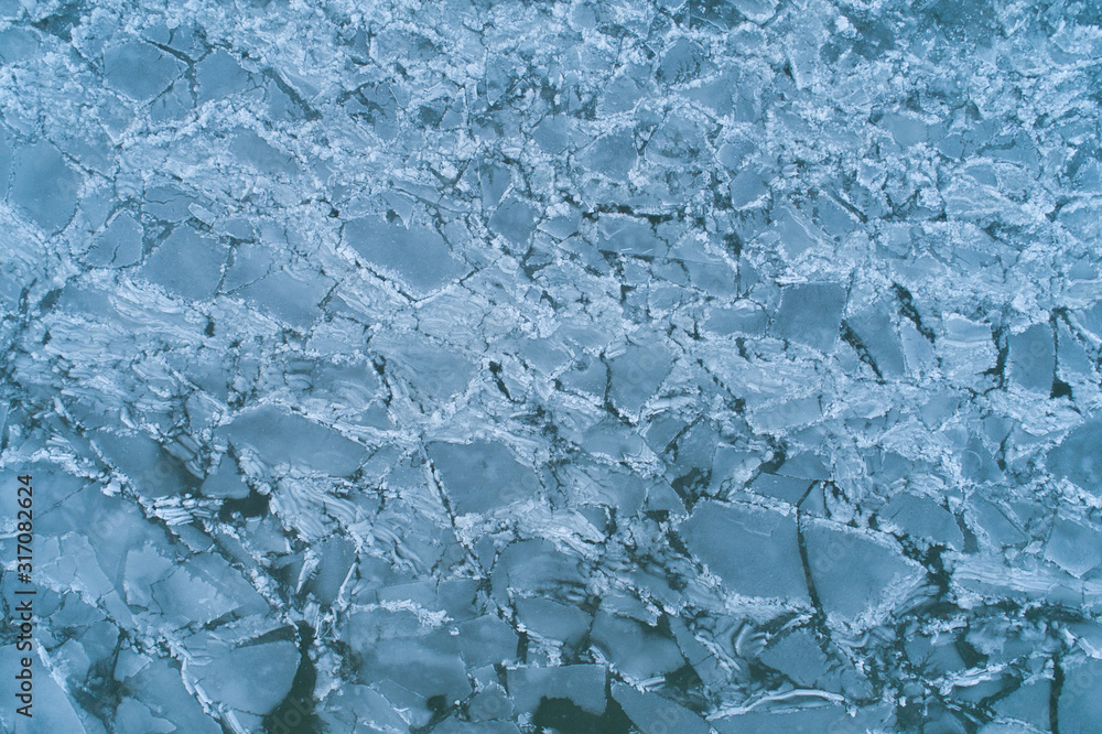 Aerial Top-Down View of Cracked, Broken, and Melting Ice on a Water Surface
