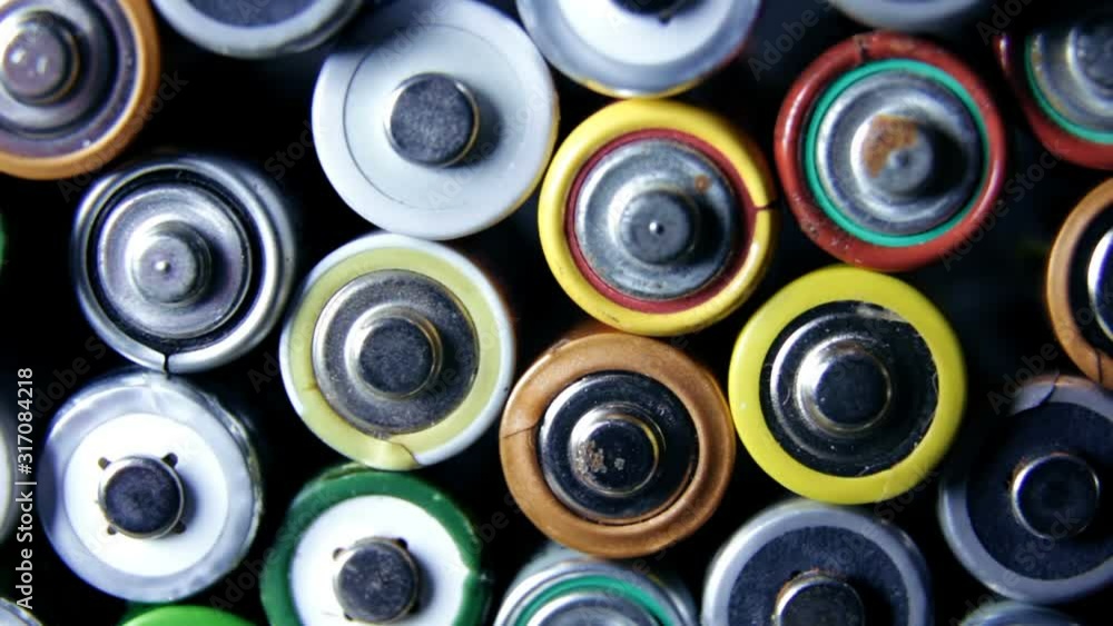 Lot of used batteries from different manufacturers. Electronic waste, collection and recycling, high danger for environment concept Lot of used batteries from different manufacturers. Electronic waste, collection and recycling, high danger for environment concept