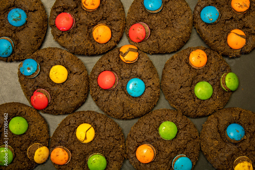 Chocolate Cookies with colorful chocolate candy on Black background photo