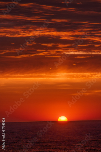 Fototapeta Naklejka Na Ścianę i Meble -  a yellow and orange morning sunrise over the Atlantic Ocean as seen from Atlantic City NJ while on vacation	