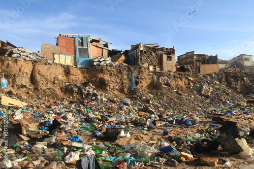 trash hills and ruins next to the sea