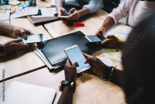 Anonymous people using smartphones in office