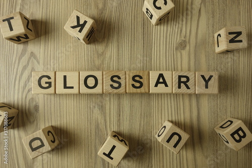 Word glossary from wooden blocks on desk