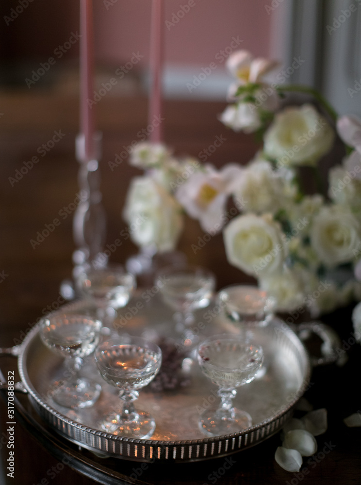  wine glasses with a drink on a vintage tray and a bouquet