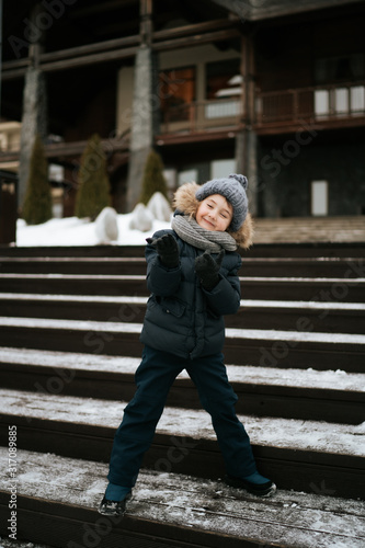 boy making funny grimaces outoors in winter time