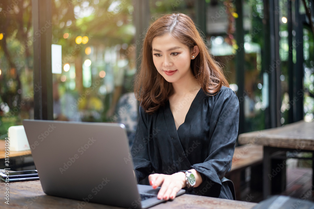 Smart Asian female is working with laptop computer Smart Asian female is working with laptop computer