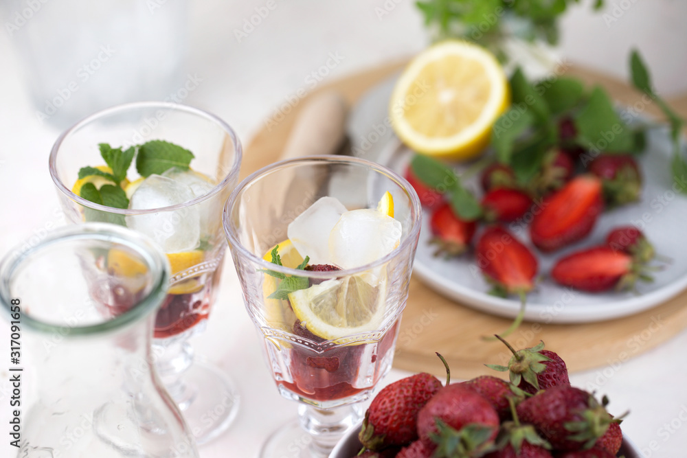 cold strawberry lemonade juice in the glasses with ice cubes cold strawberry lemonade juice in the glasses with ice cubes
