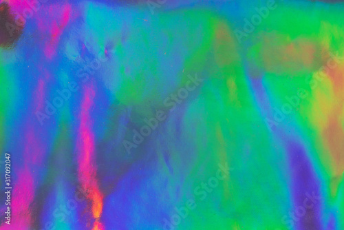 Photo texture of a fashionable holographic film. Abstract colorful holographic futuristic texture.