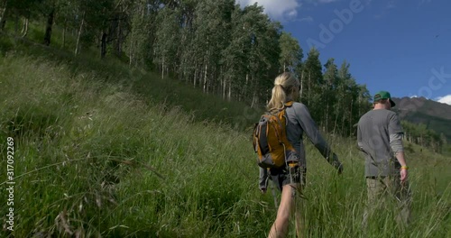 Couple Hiking Colorado Mountain Trail with Dog Tall Grass