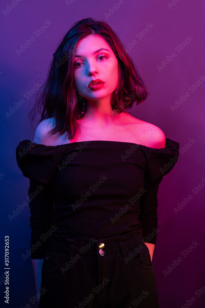 Fashion portrait girl light neon Blue and pink. woman in colorful lights on a gray background. Beautiful sexy girl with trendy make-up Fashion portrait girl light neon Blue and pink. woman in colorful lights on a gray background. Beautiful sexy girl with trendy make-up