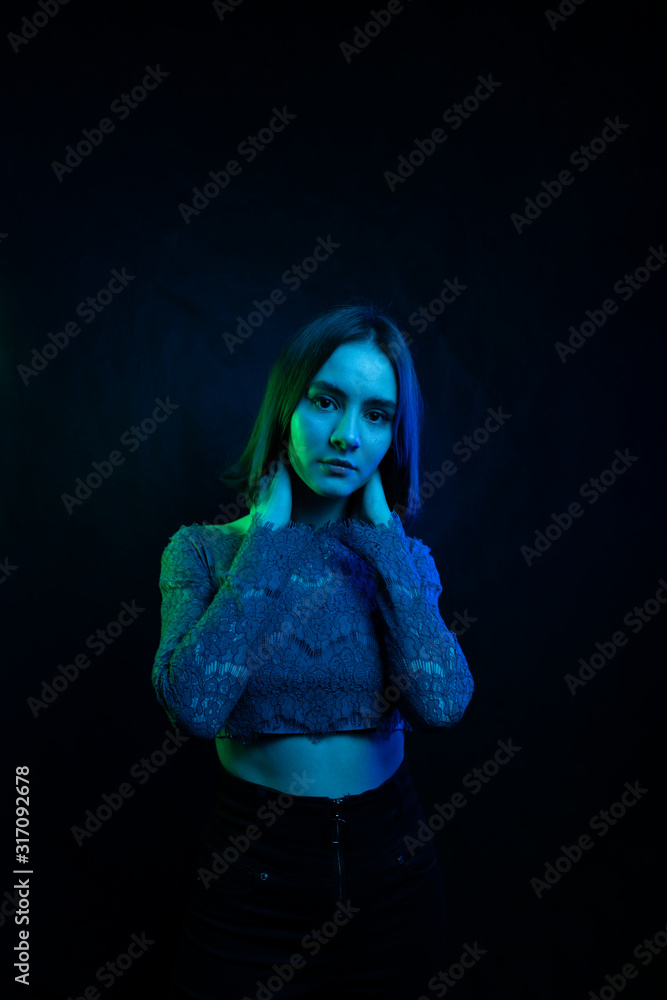 Fashion portrait girl light neon blue and green. woman in colorful lights on Black background. Beautiful sexy girl with trendy make-up Fashion portrait girl light neon blue and green. woman in colorful lights on Black background. Beautiful sexy girl with trendy make-up