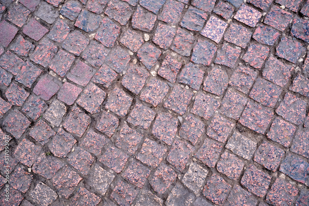 Background. The road is made of granite cobblestones. Background. The road is made of granite cobblestones.