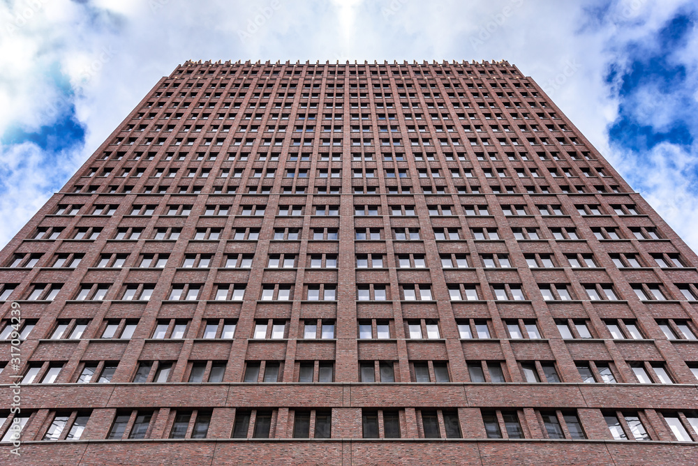 A tall building against an overcast dark sky. A tall building against an overcast dark sky.
