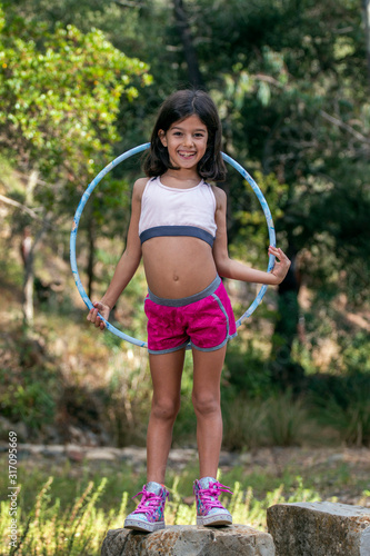 Cute girl posing with hula hoop