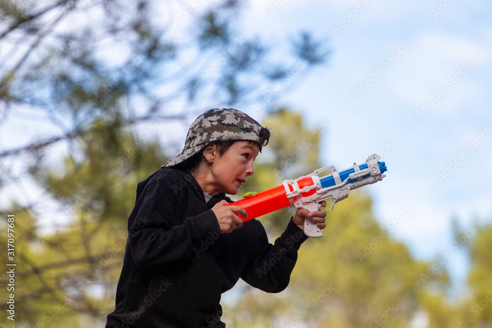 Naklejka premium Cute boy with water gun