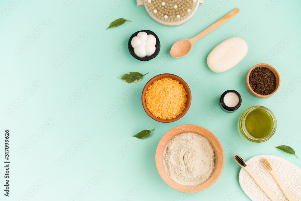 Cosmetic bath salt, grape gomaj for the face, coffee scrub for the body on a mint background. Spa cosmetic, zero waste. Cosmetic bath salt, grape gomaj for the face, coffee scrub for the body on a mint background. Spa cosmetic, zero waste.
