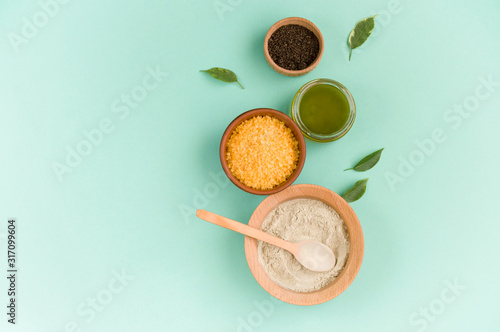 Cosmetic bath salt, grape gomaj for the face, coffee scrub for the body on a mint background. Spa cosmetic, zero waste.