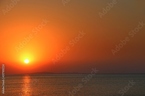 Sunset above sea. Beautiful summer decline above ocean © alexmak