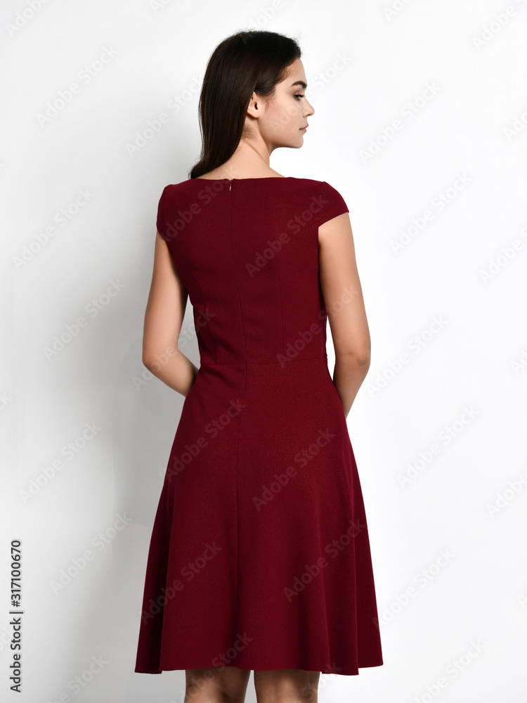 Young beautiful woman posing in new fashion casual red cherry winter dress skirt on white background Young beautiful woman posing in new fashion casual red cherry winter dress skirt on white background