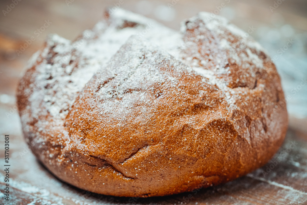 Traditional bread with a crust on a wooden board Traditional bread with a crust on a wooden board