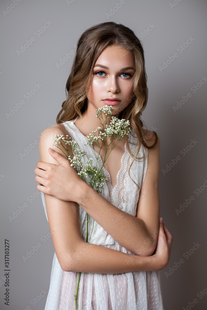 Portrait of a very beautiful young model in bridal dress with