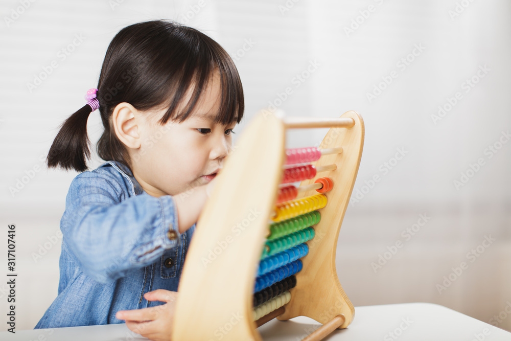 toddler girl play abacus for learning math at home against white background toddler girl play abacus for learning math at home against white background