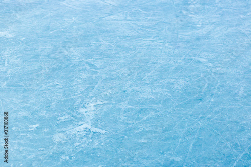 Abstract ice texture. Nature blue background. Traces of blades of skates on ice