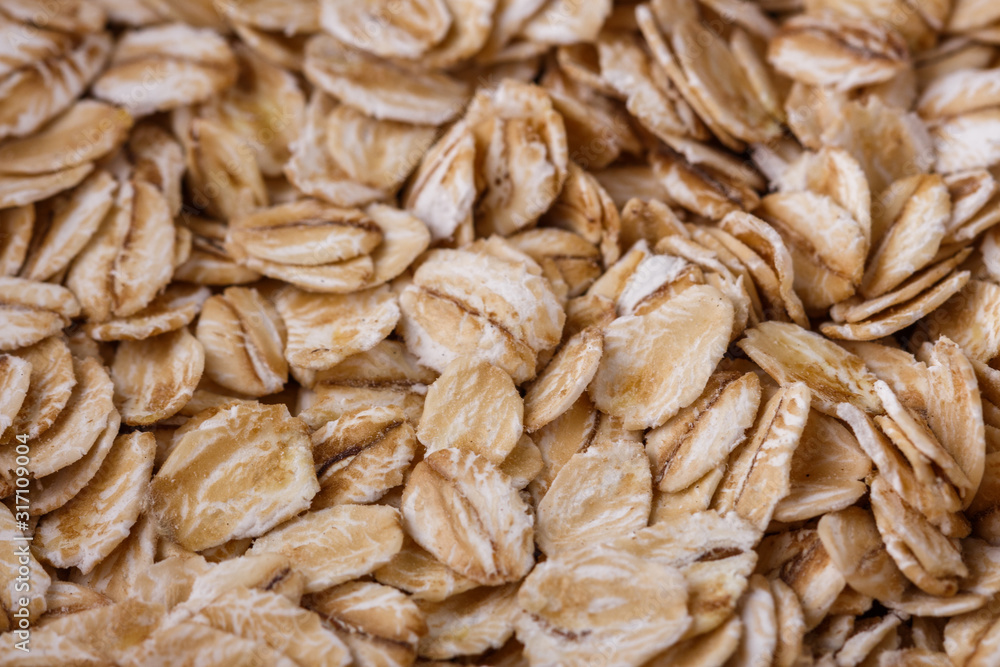 raw oat flakes on white acrylic background raw oat flakes on white acrylic background