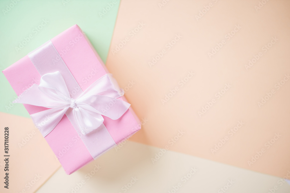 Creative holiday present. Handmade paper gift box on multicolored backdrop. Valentine's, Mother's or Women's Day background. Copy space Creative holiday present. Handmade paper gift box on multicolored backdrop. Valentine's, Mother's or Women's Day background. Copy space