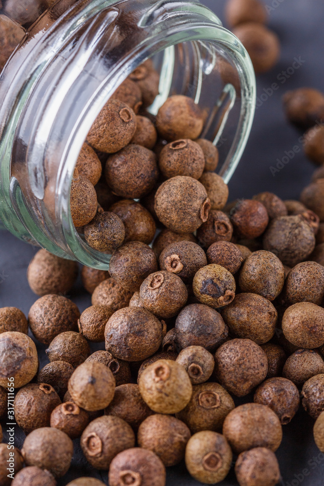 fresh spicy peppers allspice on a dark stone background fresh spicy peppers allspice on a dark stone background