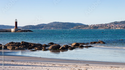 View of Vigo estuary, Sea Museum beacon and Cangas village from Carril beach