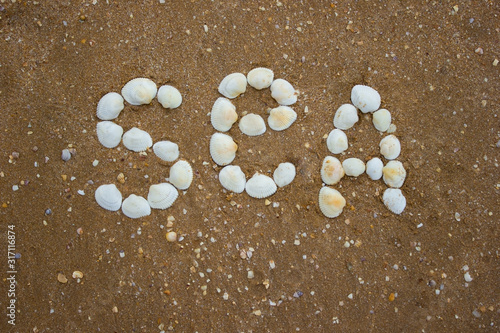Inscription on sand from shells - the sea, camping, tourism © alexey_m