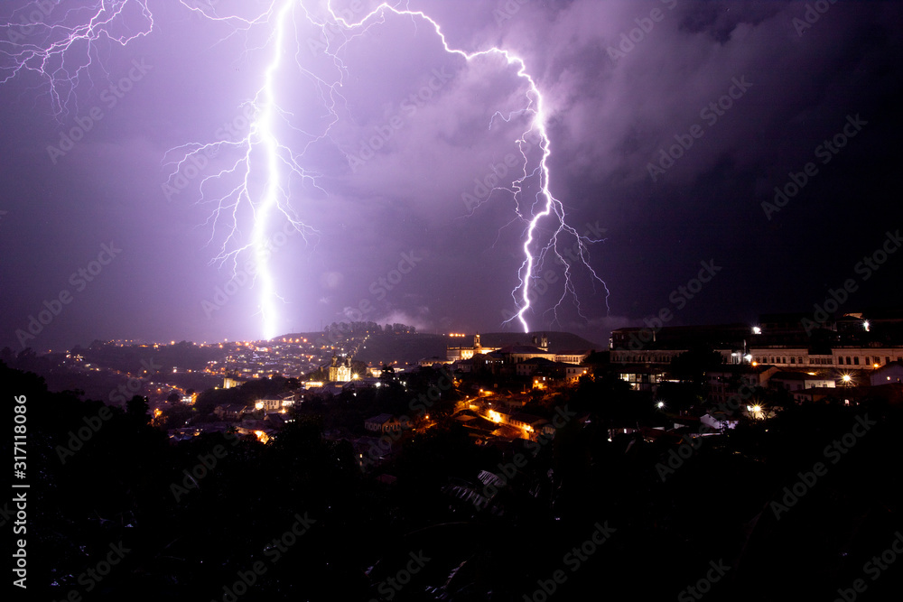 Incredible bright lightning strikes in historic city centre of Ouro