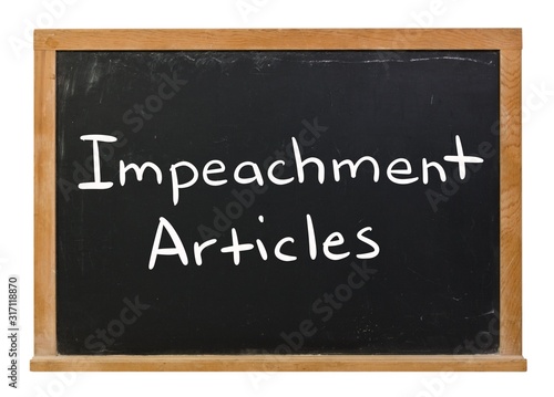 Impeachment articles written in white chalk on a black chalkboard isolated on white