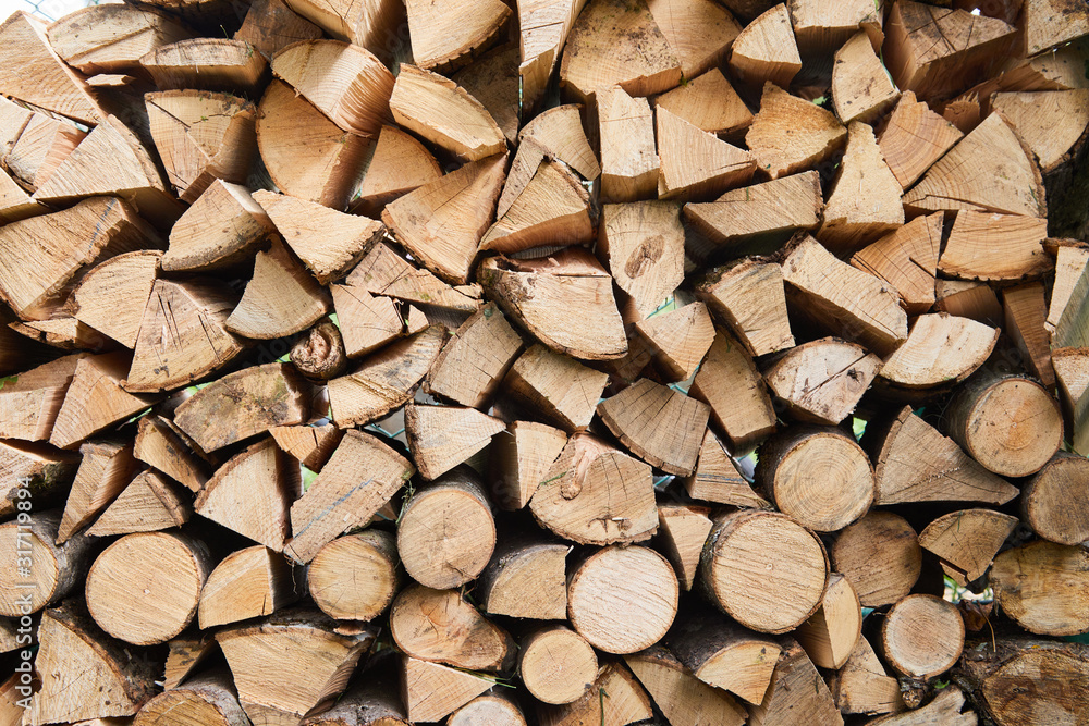 Stacks of firewood in the sawmill. Pile of firewood. Firewood background Stacks of firewood in the sawmill. Pile of firewood. Firewood background