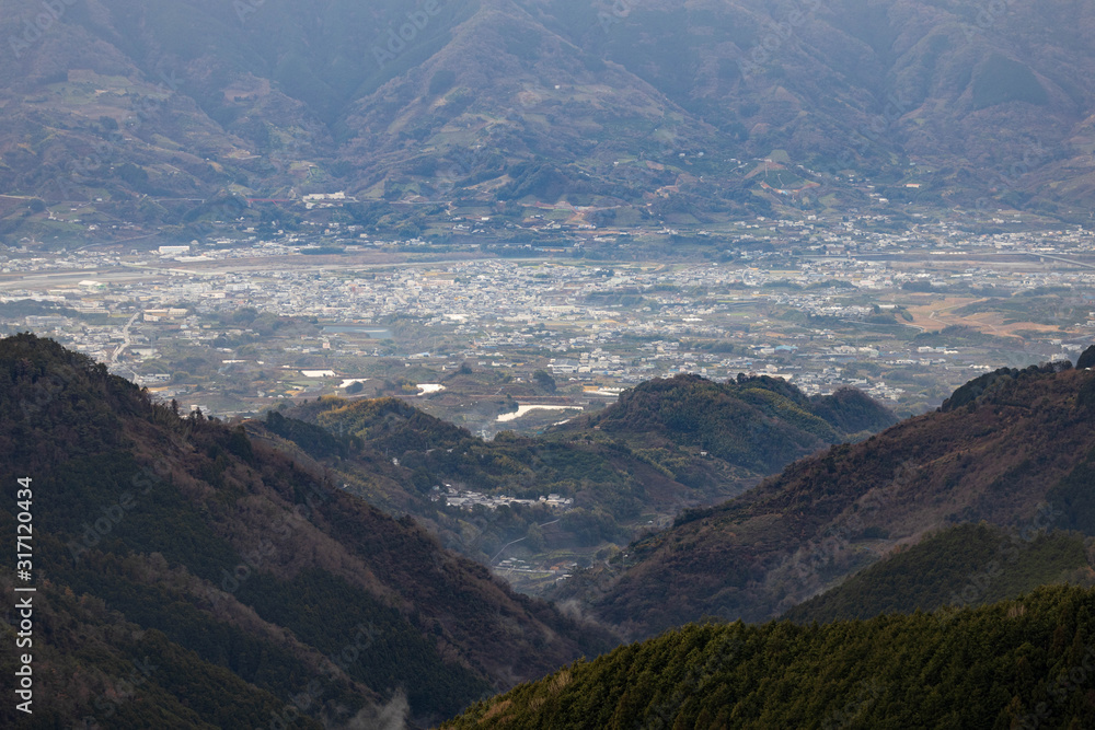 Looking down at Kinokawa, a small Japanese town nestled in valley between mountains