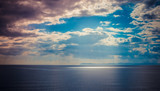 Seascape, blue sky background with clouds