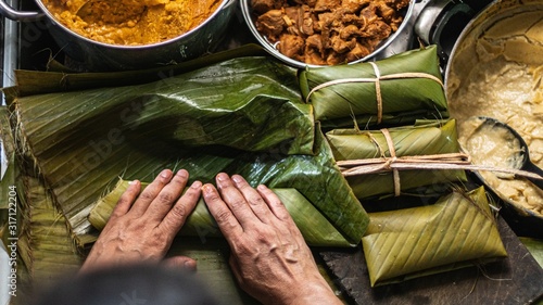 Photo Overhead   shot of person preparing honduran tamales